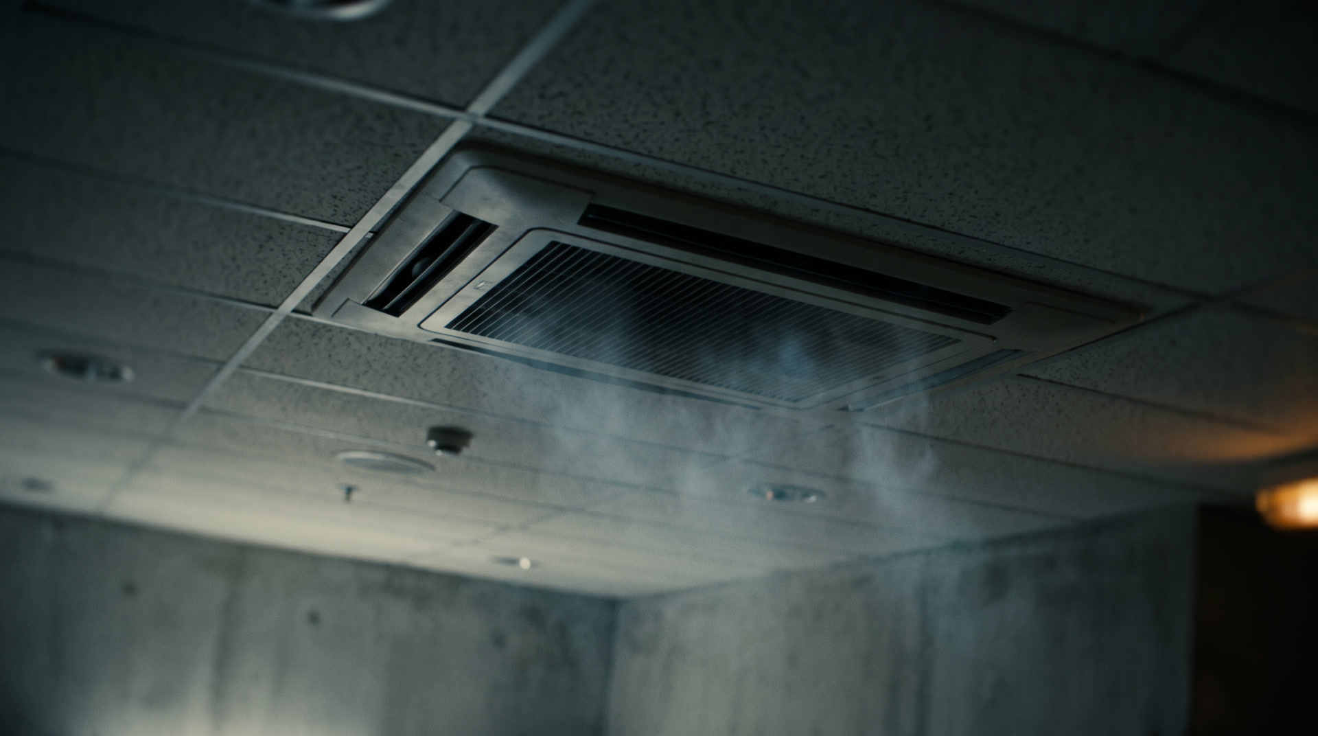 Ceiling air-conditioning vent with mist drifting in cool light